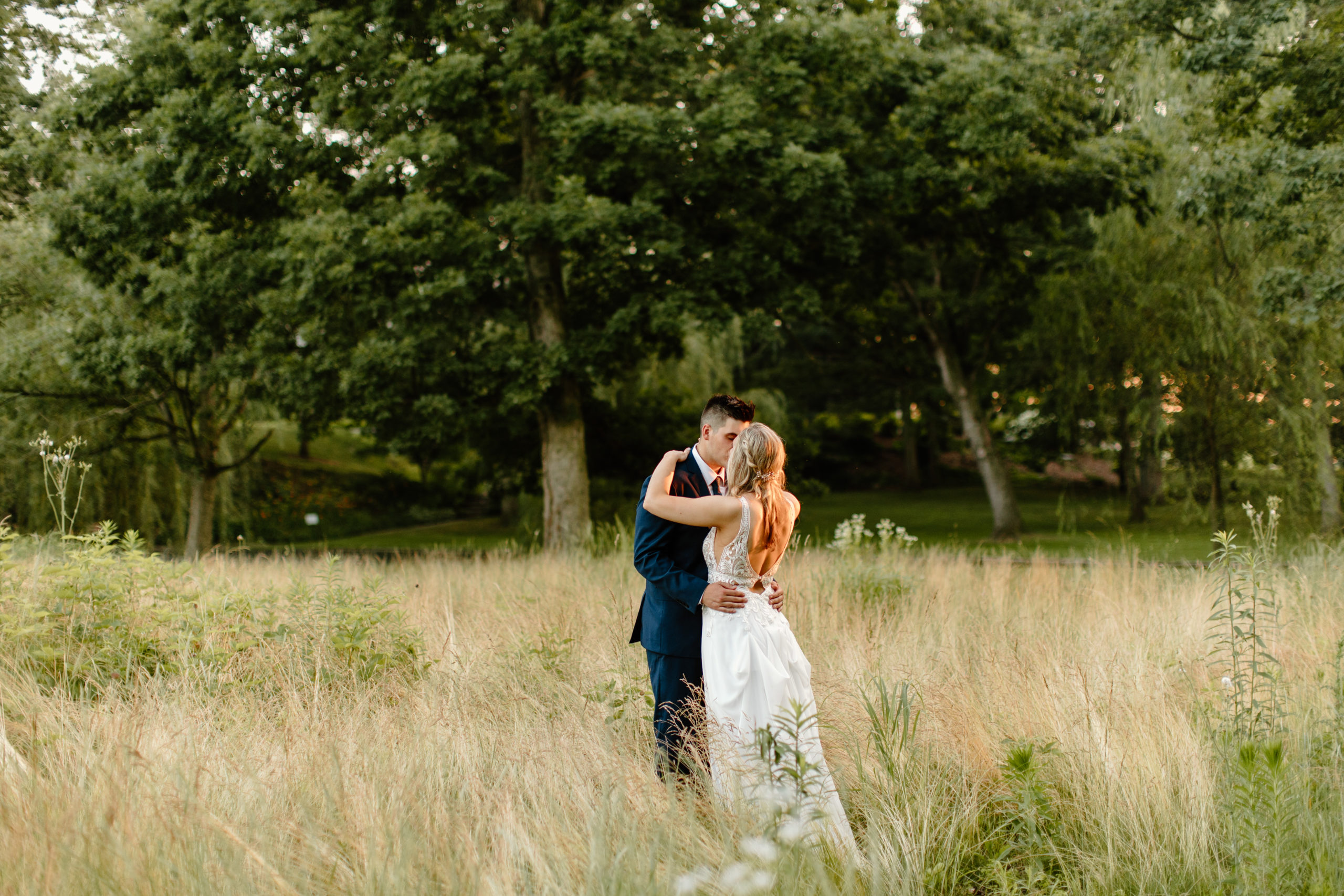 Bride and groom in field at wedding
